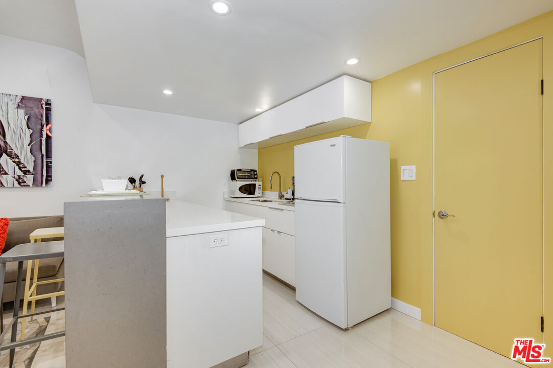 508 North Kings Road, Unit 5 West Hollywood, CA 90048 - Photo 8 of 8 a utility room with cabinets washer and dryer