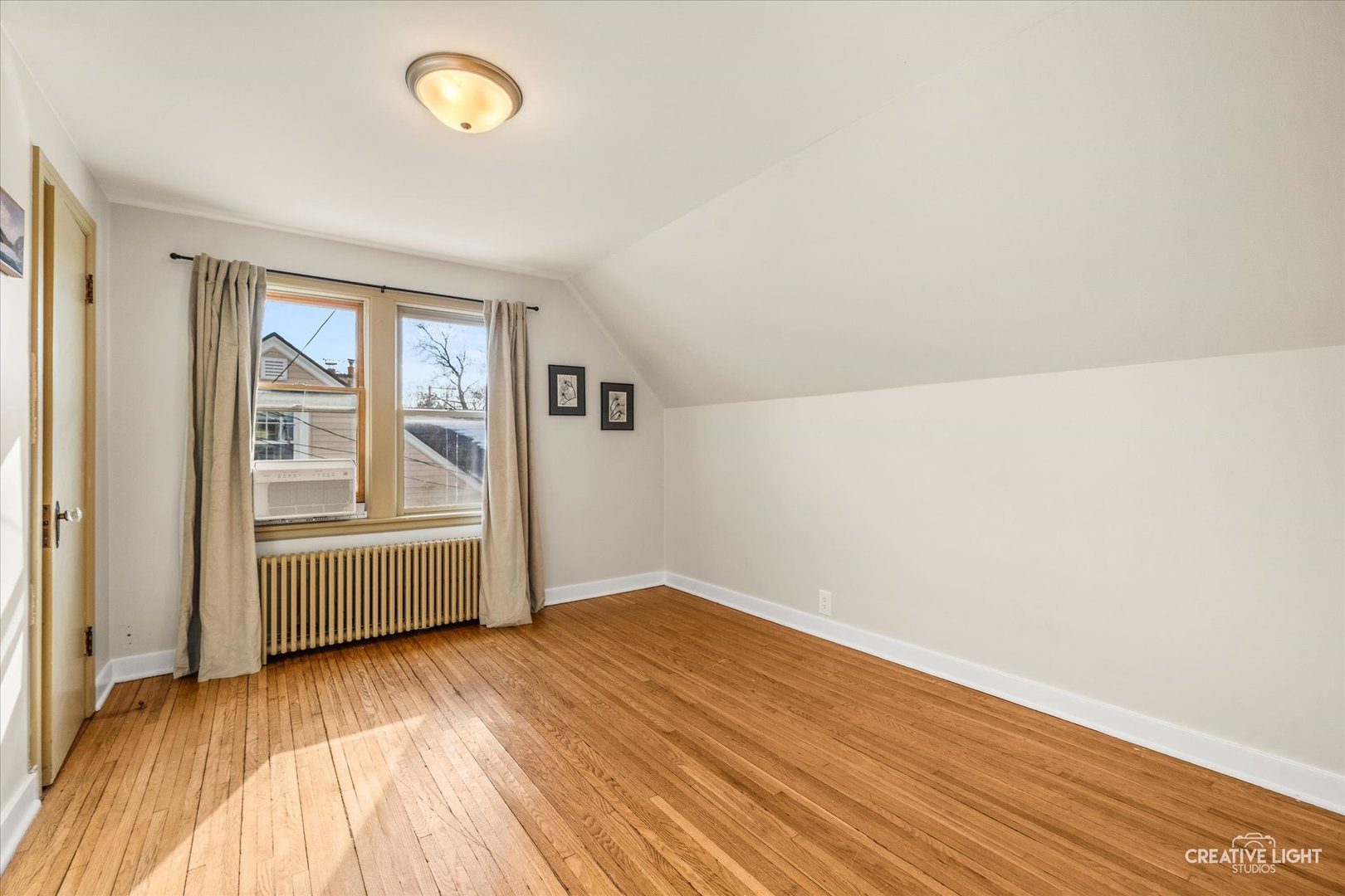 523 Preston Avenue Elgin, IL 60120 - Photo 13 of 22 an empty room with wooden floor and windows