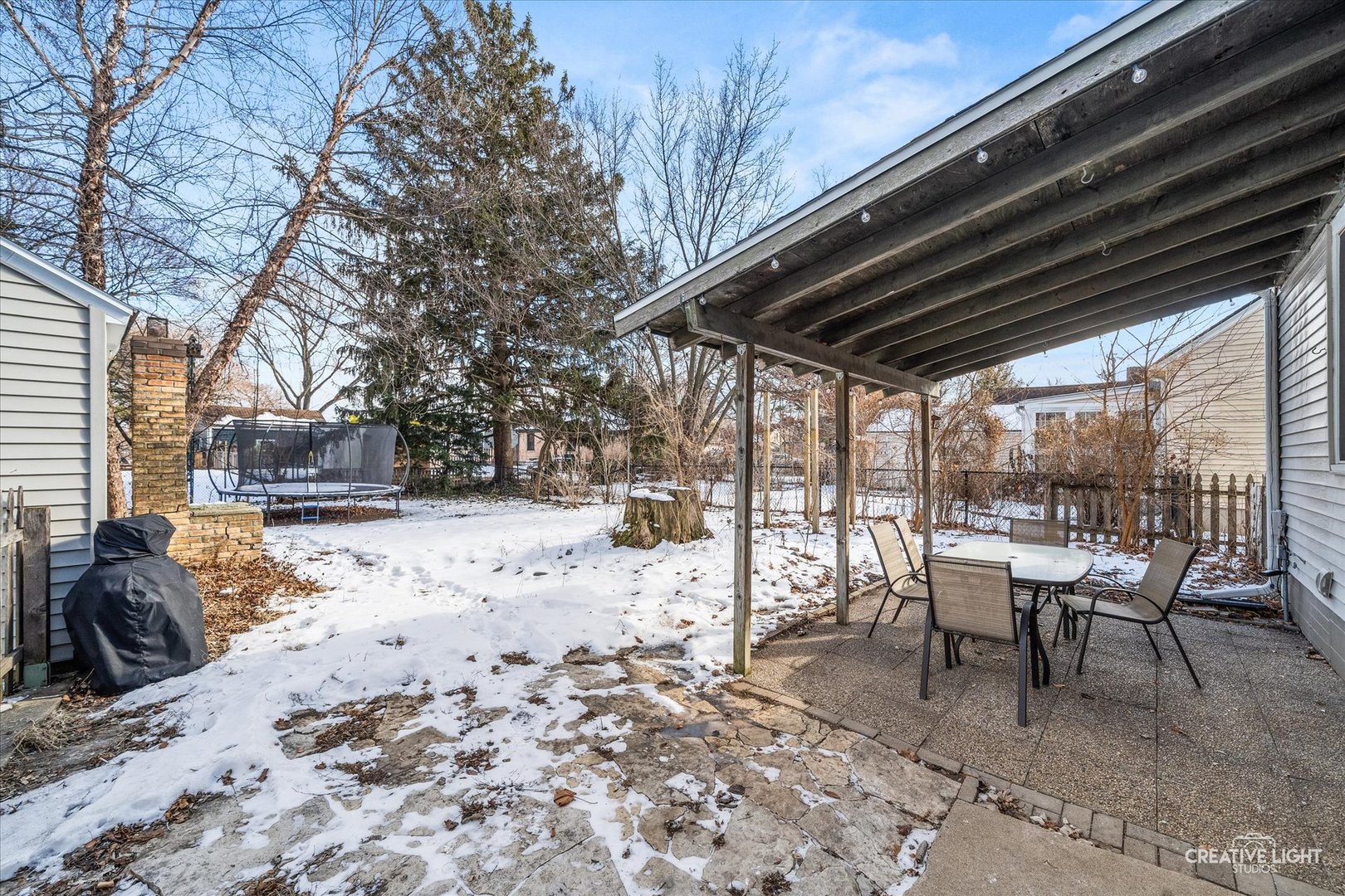 523 Preston Avenue Elgin, IL 60120 - Photo 16 of 22 a view of a backyard with table and chairs and couches with wooden fence
