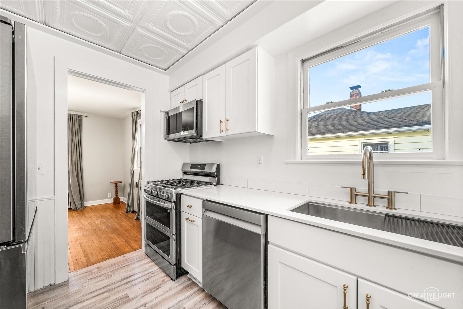523 Preston Avenue Elgin, IL 60120 - Photo 3 of 22 a kitchen with stainless steel appliances white cabinets a sink and a stove