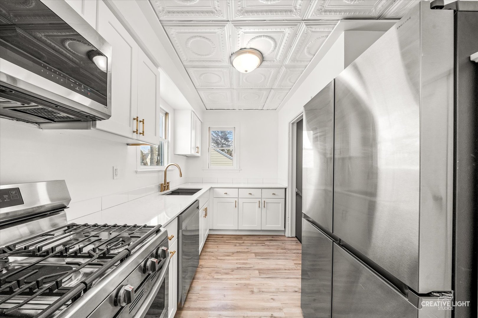 523 Preston Avenue Elgin, IL 60120 - Photo 5 of 22 a kitchen with stainless steel appliances granite countertop a stove and a refrigerator