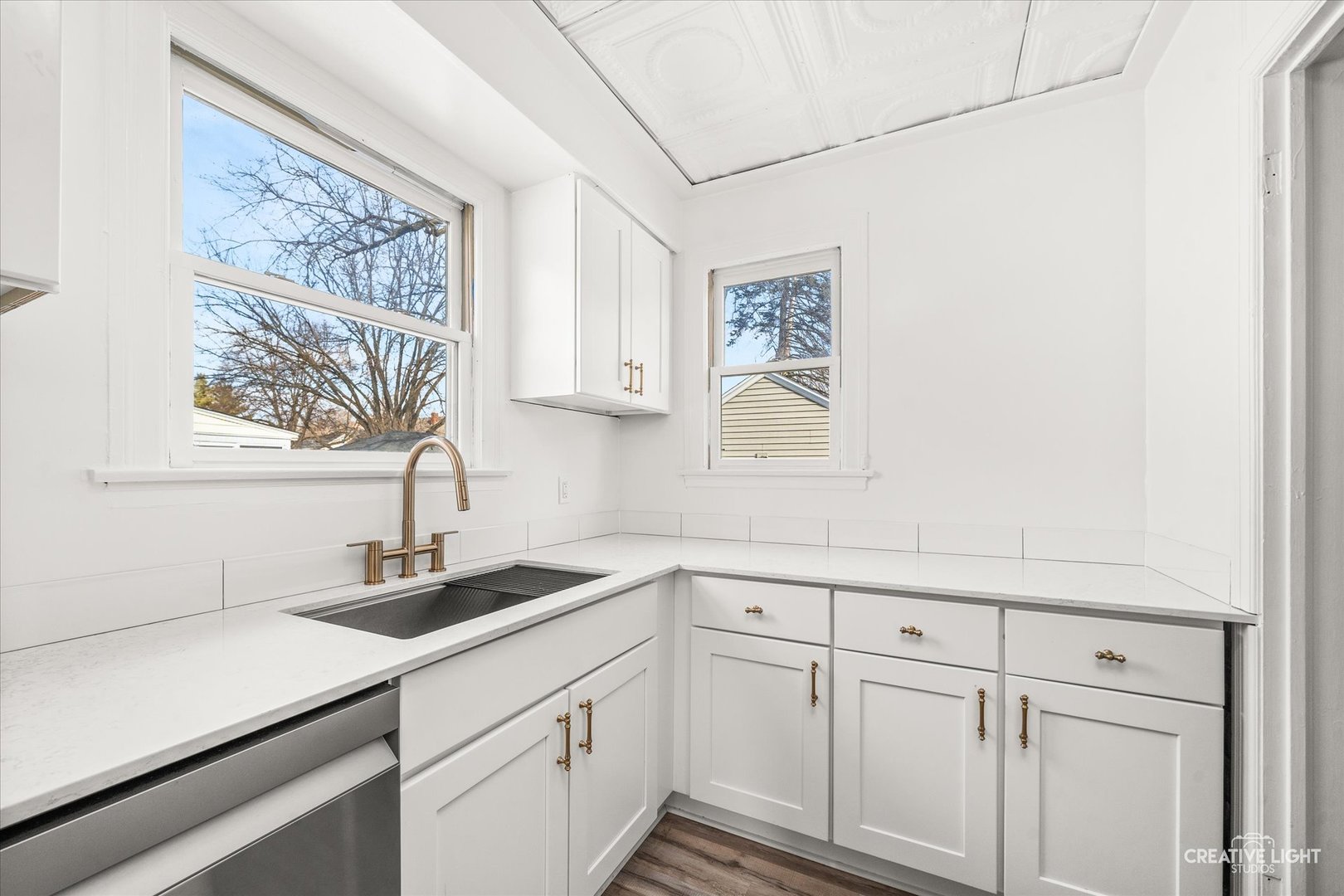 523 Preston Avenue Elgin, IL 60120 - Photo 6 of 22 a kitchen with white cabinets and sink