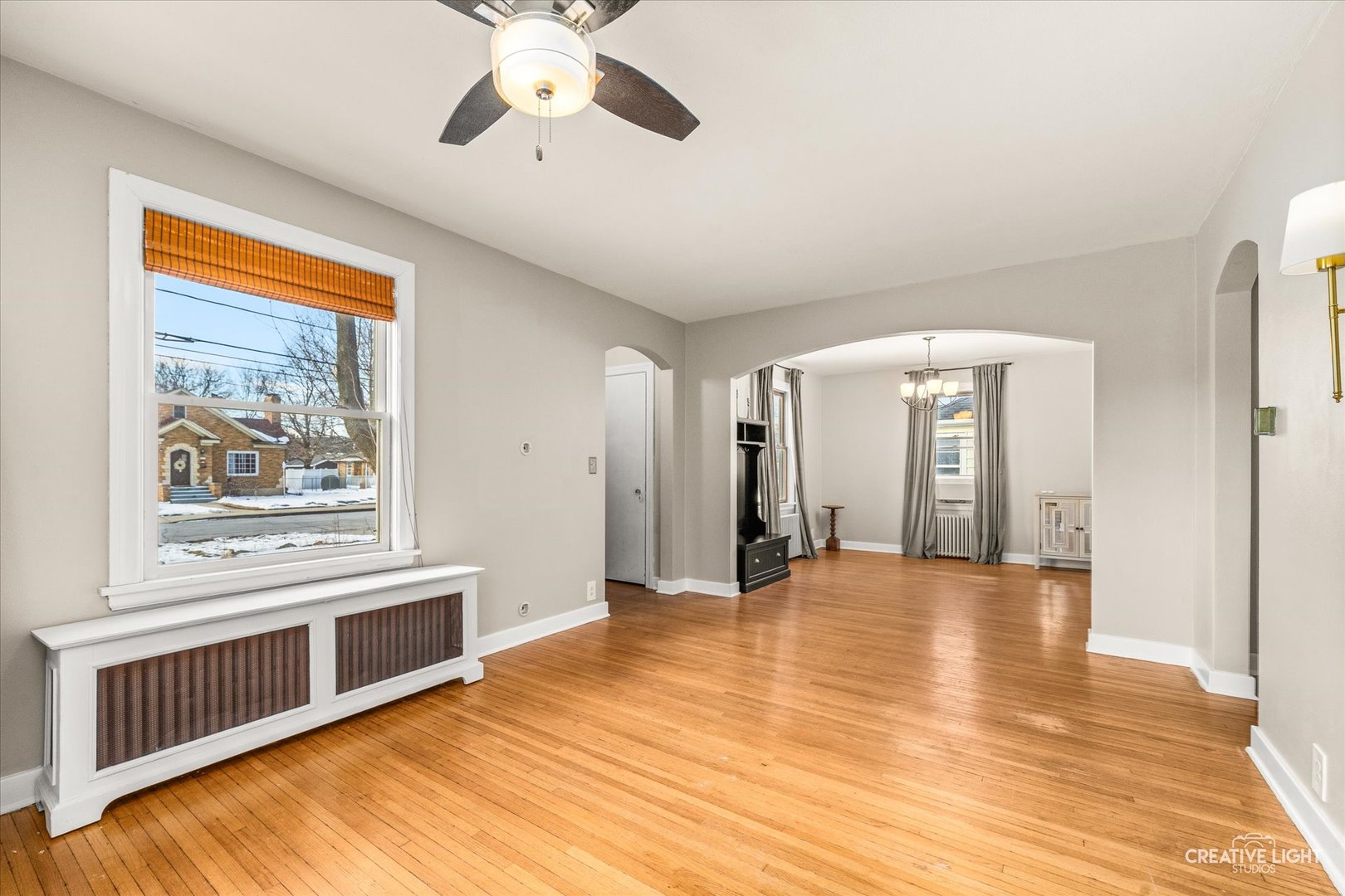 523 Preston Avenue Elgin, IL 60120 - Photo 8 of 22 a view of an empty room with window and wooden floor
