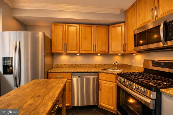a kitchen with a stove a sink and a microwave