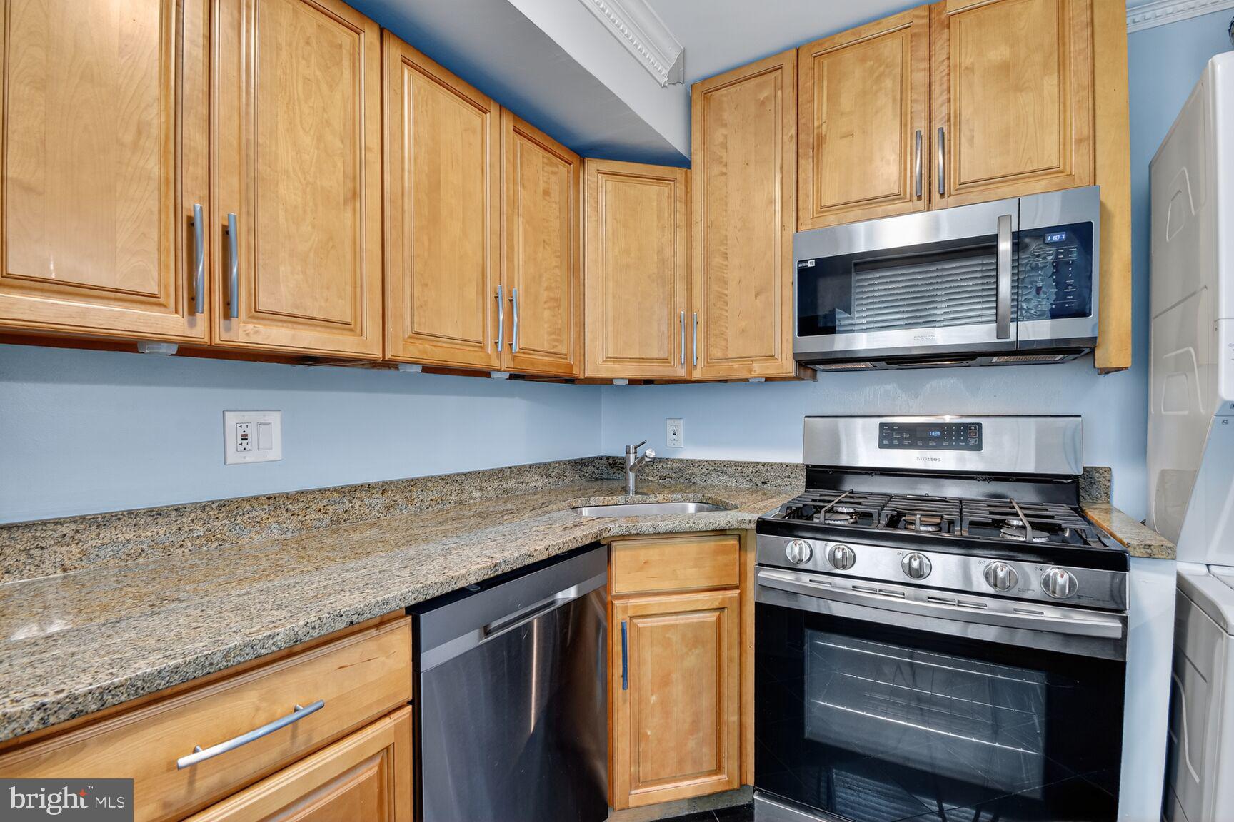 3976 Bel Pre Road, Unit 1 Silver Spring, MD 20906 - Photo 4 of 19 a kitchen with granite countertop cabinets stainless steel appliances and a window