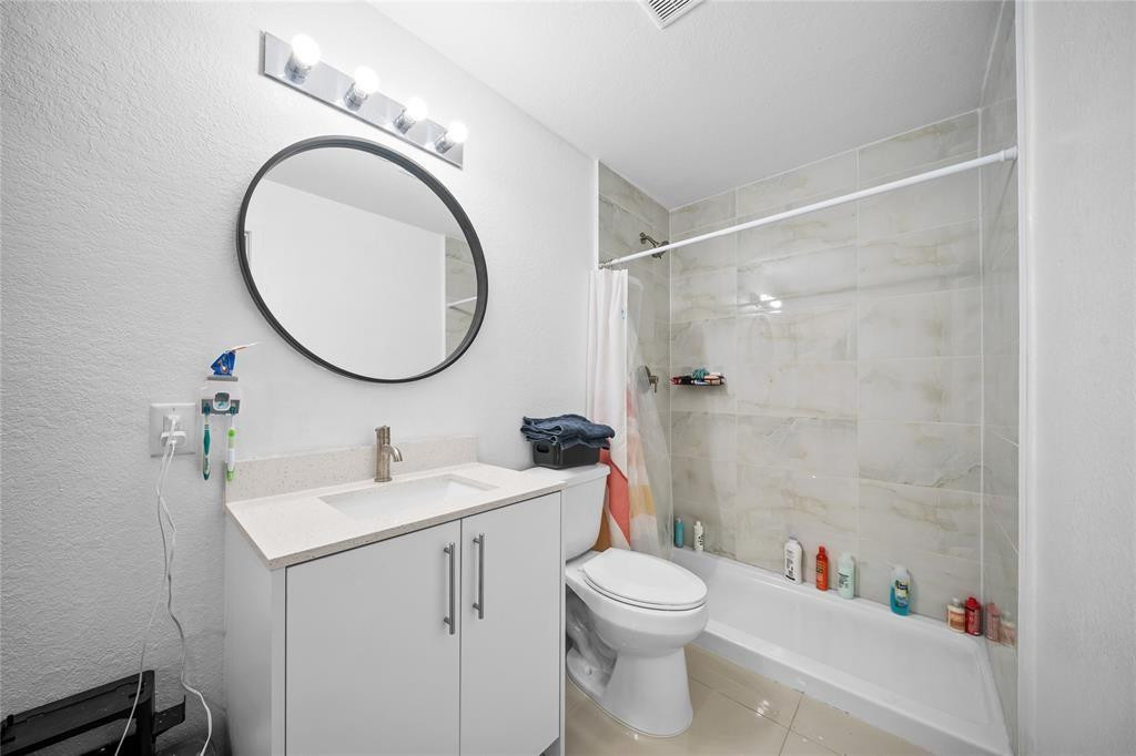 14474 Southwest 259th Street Homestead, FL 33032 - Photo 11 of 25 a bathroom with a toilet sink and a mirror