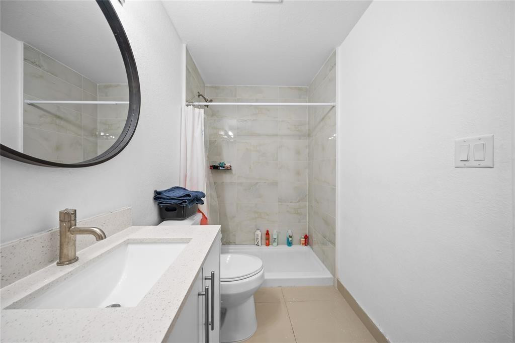 14474 Southwest 259th Street Homestead, FL 33032 - Photo 12 of 25 a bathroom with a sink a toilet and a mirror