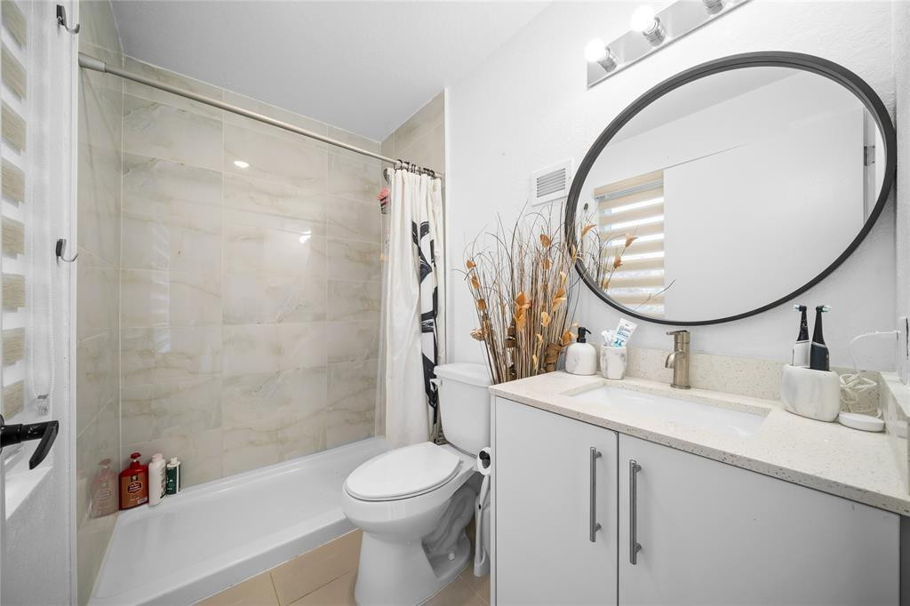 14474 Southwest 259th Street Homestead, FL 33032 - Photo 17 of 25 a bathroom with a sink a toilet and a mirror