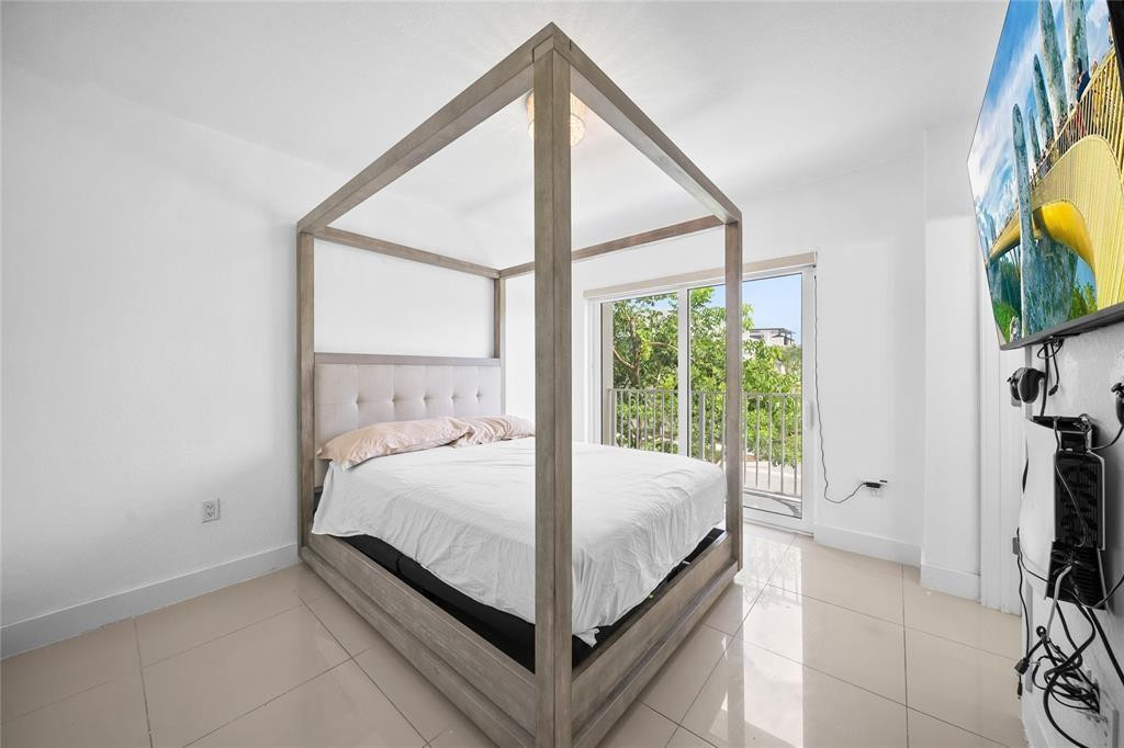 14474 Southwest 259th Street Homestead, FL 33032 - Photo 18 of 25 a bed sitting in a bedroom next to a window