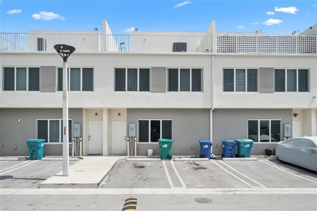 14474 Southwest 259th Street Homestead, FL 33032 - Photo 20 of 25 a front view of a building with parking space