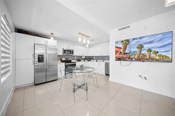 a kitchen with stainless steel appliances granite countertop a refrigerator and microwave