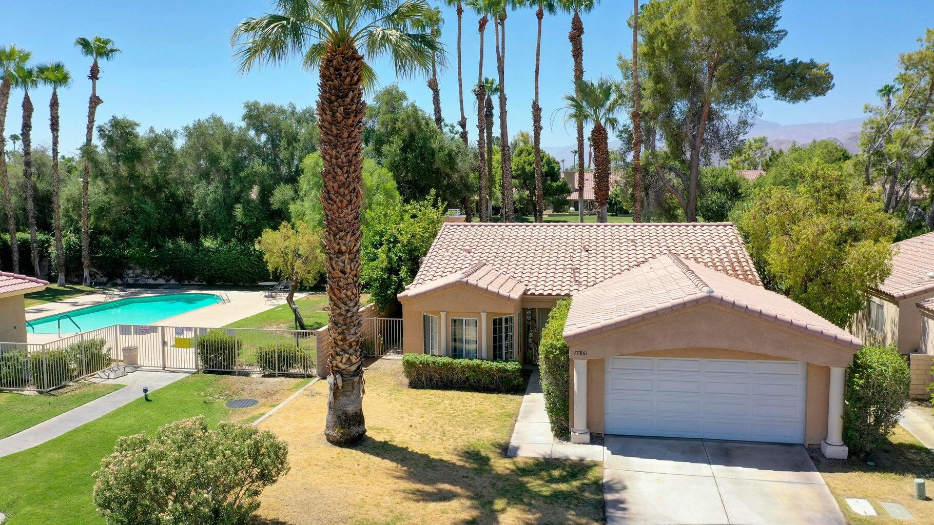 77861 Villa Road Palm Desert, CA 92211 - Photo 1 of 24 a front view of a house with garden