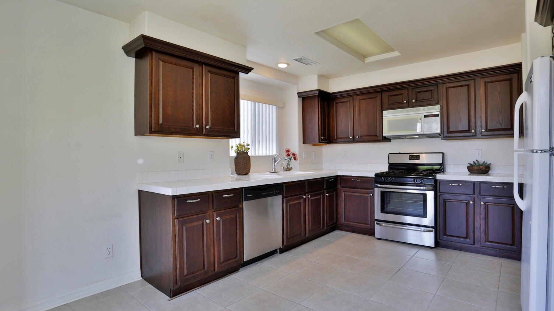 77861 Villa Road Palm Desert, CA 92211 - Photo 12 of 24 a kitchen with stainless steel appliances granite countertop a stove sink and cabinets