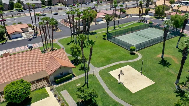 an aerial view of a house with garden space and street view