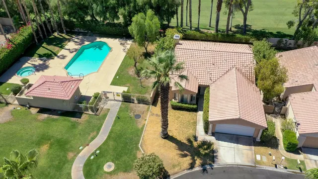an aerial view of a house with a swimming pool