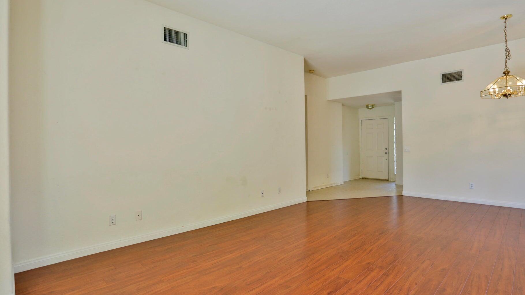77861 Villa Road Palm Desert, CA 92211 - Photo 24 of 24 an empty room with wooden floor and windows