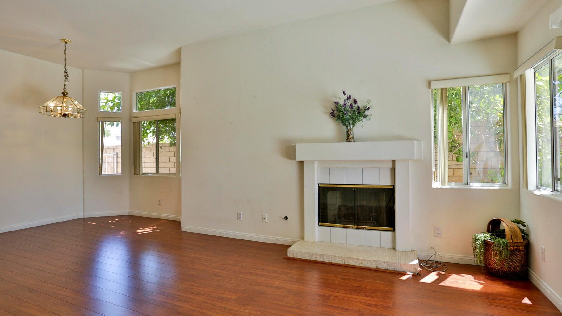 77861 Villa Road Palm Desert, CA 92211 - Photo 6 of 24 a living room with hardwood floor a fireplace and window