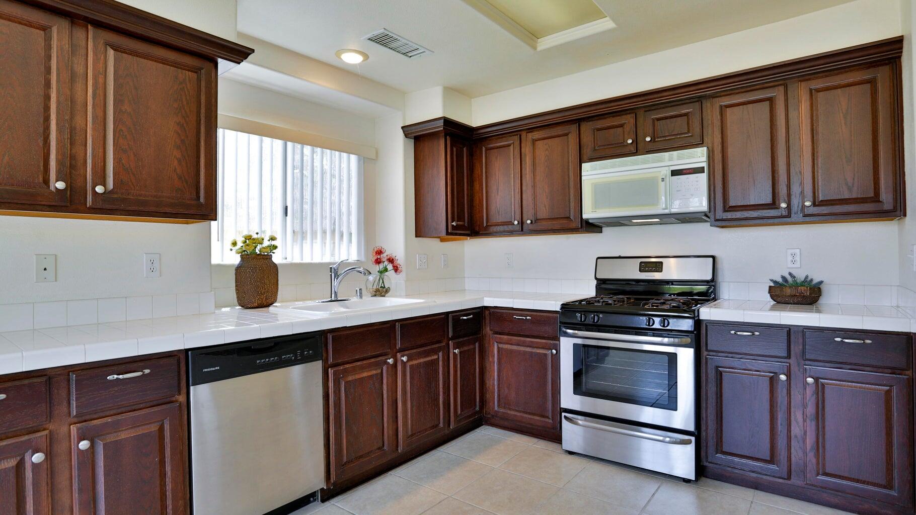77861 Villa Road Palm Desert, CA 92211 - Photo 9 of 24 a kitchen with a sink stove and cabinets