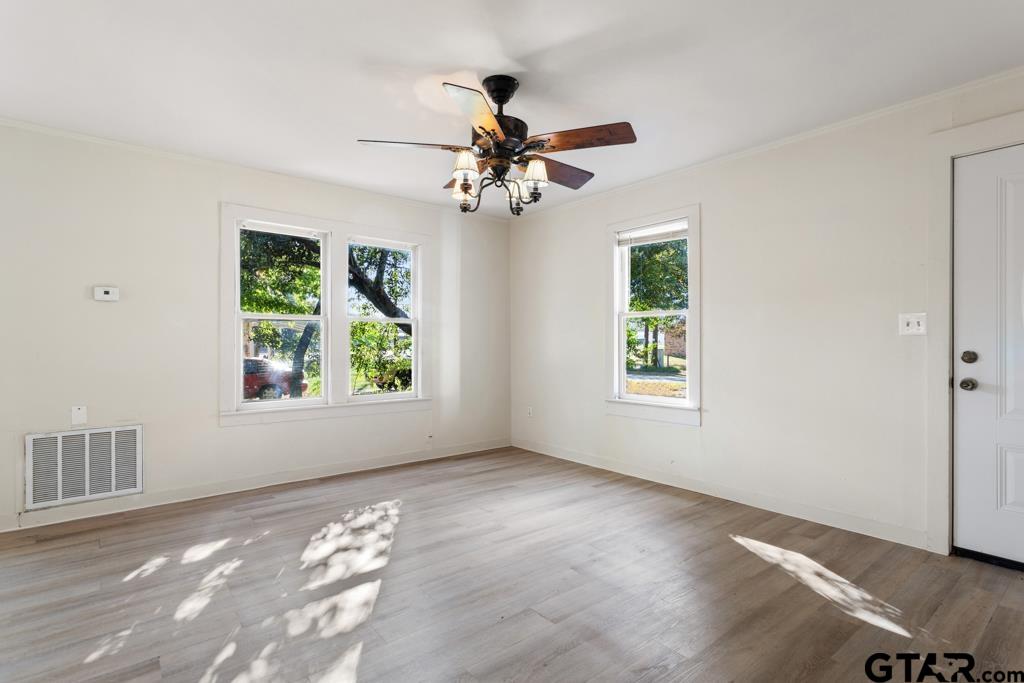 107 Mallory Street Lindale, TX 75771 - Photo 13 of 33 a view of room with window ceiling fan and hardwood floor