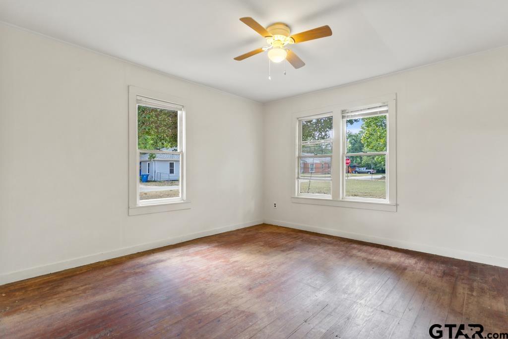 107 Mallory Street Lindale, TX 75771 - Photo 23 of 33 wooden floor in an empty room with a window