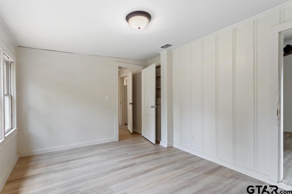 107 Mallory Street Lindale, TX 75771 - Photo 24 of 33 an empty room with wooden floor and windows