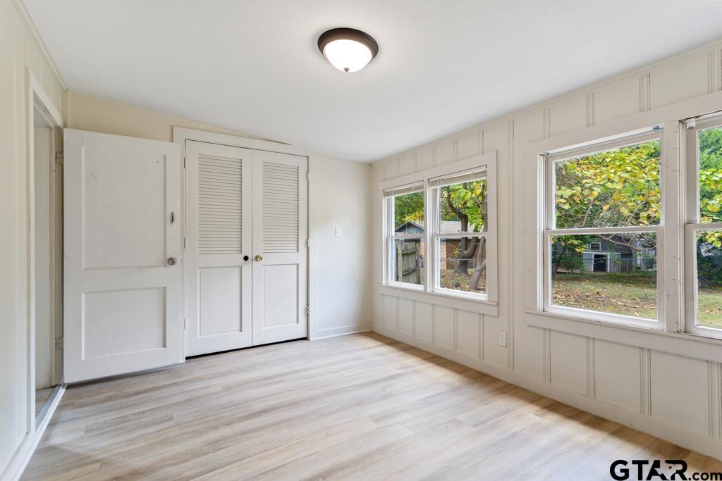 107 Mallory Street Lindale, TX 75771 - Photo 25 of 33 an empty room with wooden floor and windows