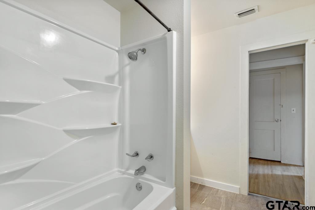 107 Mallory Street Lindale, TX 75771 - Photo 29 of 33 a bathroom with a bathtub and a shower