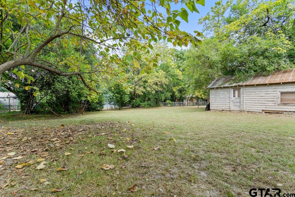 107 Mallory Street Lindale, TX 75771 - Photo 30 of 33 a view of a backyard with a garden