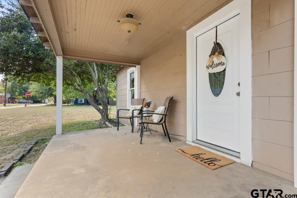 107 Mallory Street Lindale, TX 75771 - Photo 3 of 33 a view of a porch with chairs and backyard