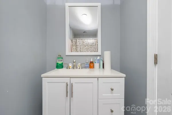 a bathroom with a sink a vanity and a mirror