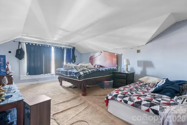 a bedroom with furniture and a lamp