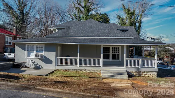 a view of a house with a wooden fence