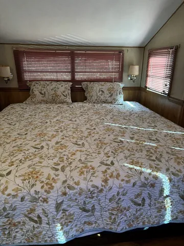 a kitchen with stainless steel appliances kitchen island granite countertop a sink stove and refrigerator