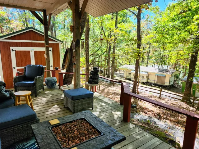 a view of backyard with roof and wooden fence