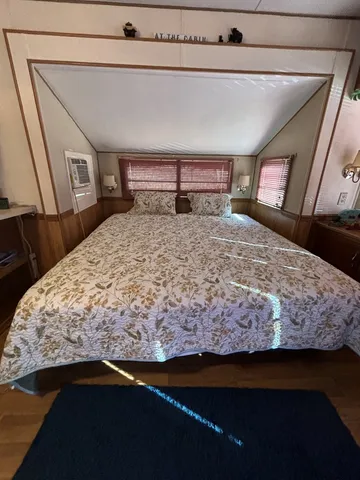 a kitchen with stainless steel appliances granite countertop a refrigerator a stove and a sink with wooden cabinets