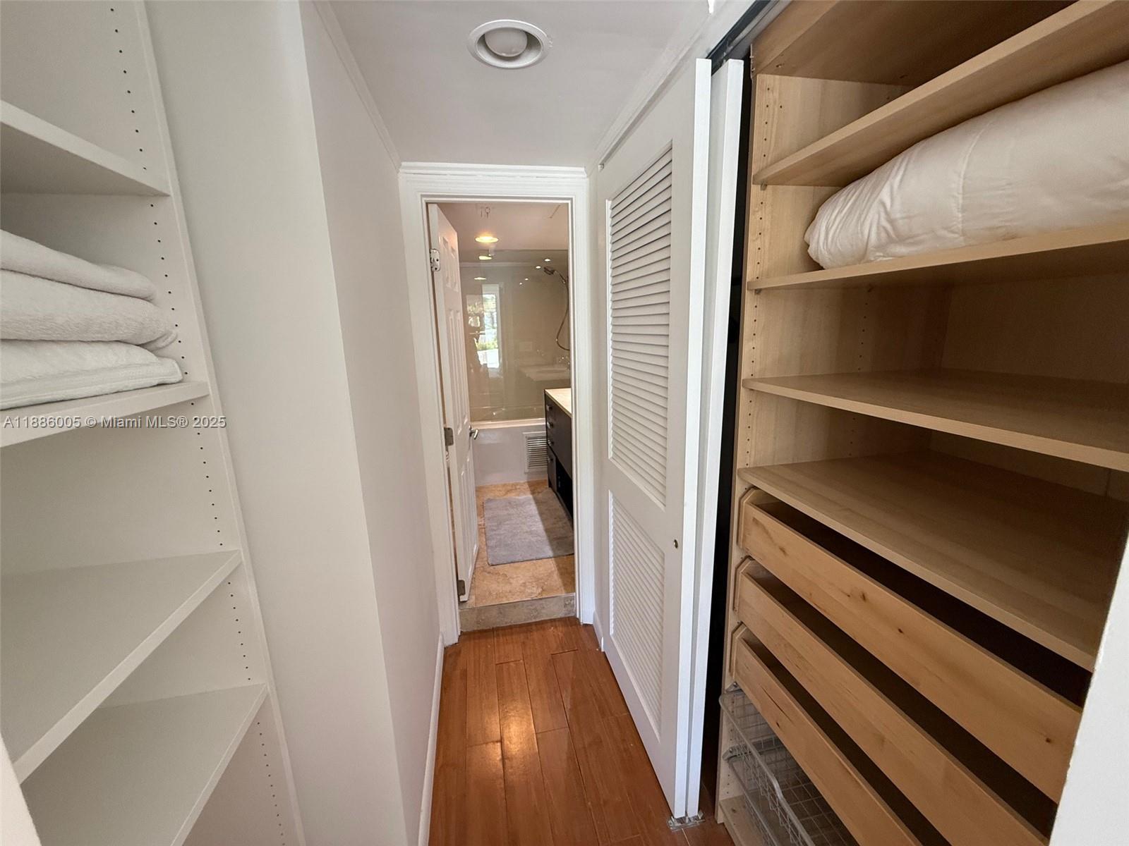 1500 Bay Road, Unit 122S Miami Beach, FL 33139 - Photo 16 of 44 a view of a hallway with wooden floor and staircase