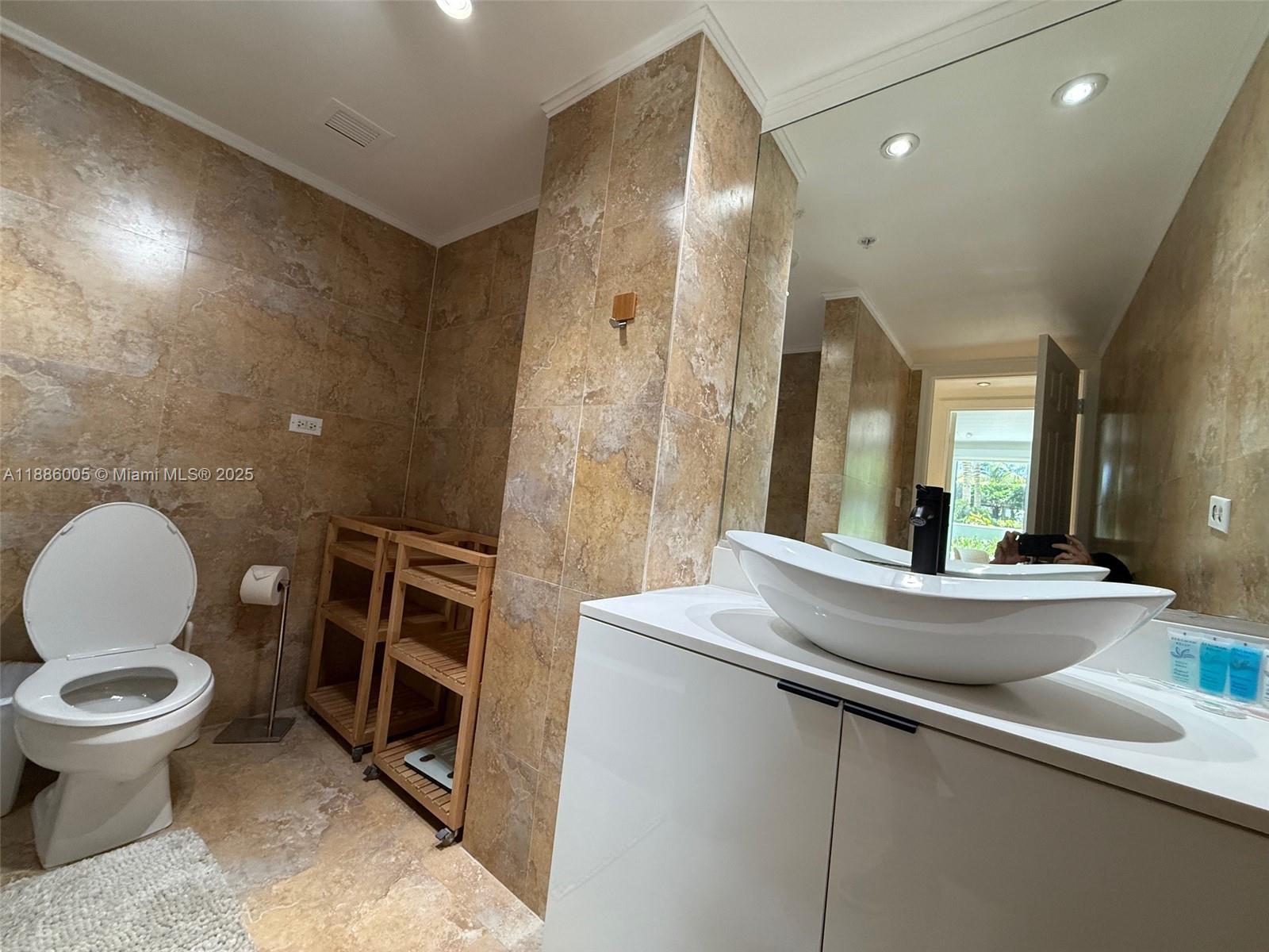 1500 Bay Road, Unit 122S Miami Beach, FL 33139 - Photo 21 of 44 a bathroom with a sink and a mirror