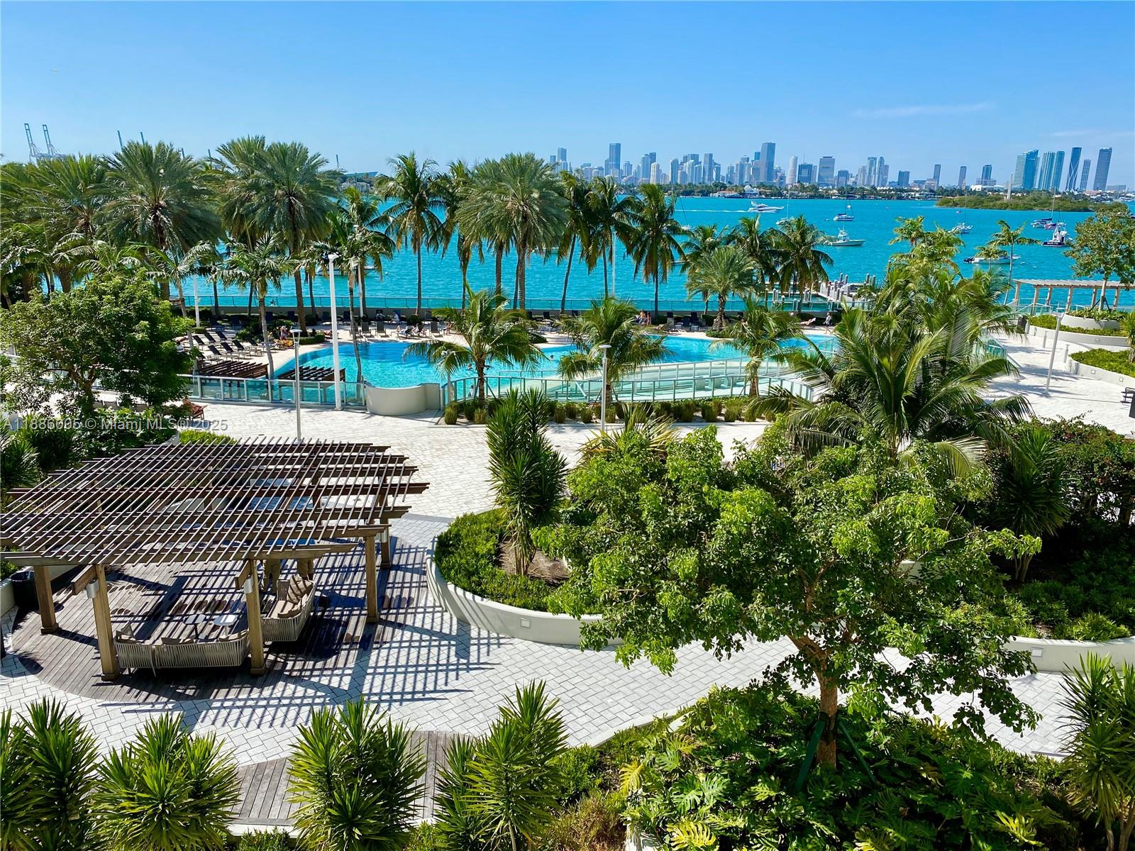 1500 Bay Road, Unit 122S Miami Beach, FL 33139 - Photo 40 of 44 a view of a lake with a bench and a yard