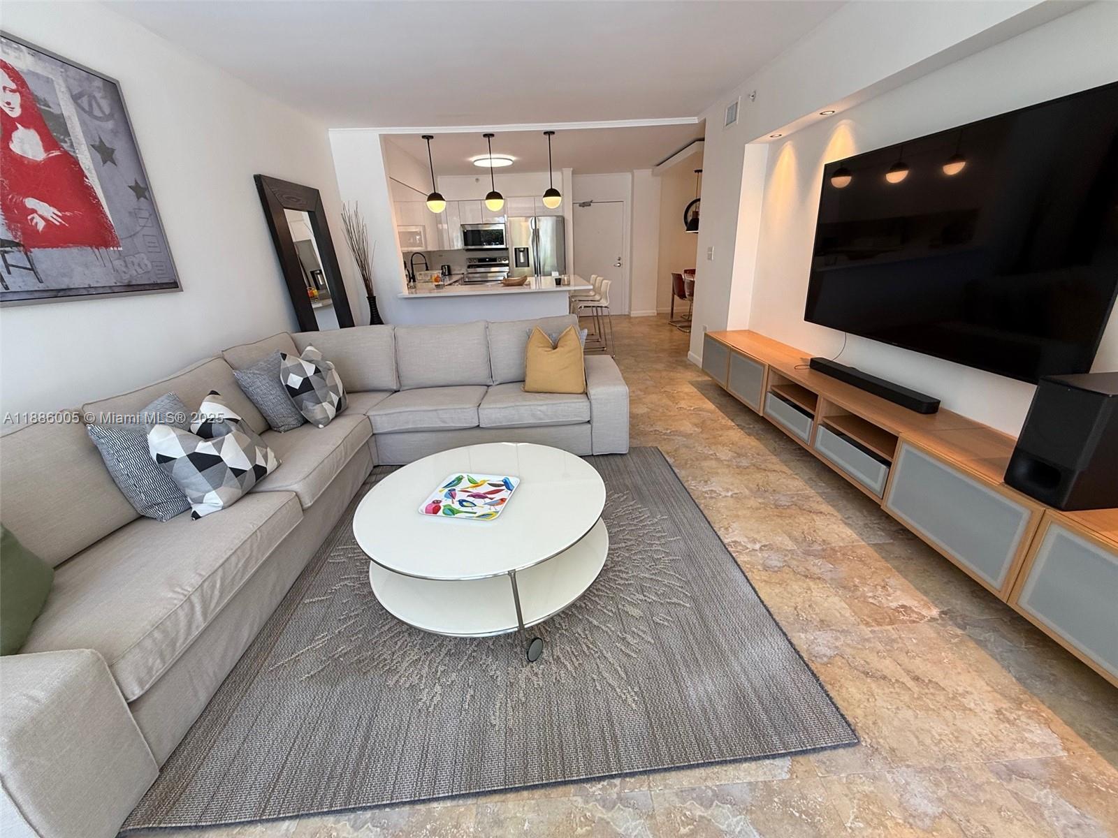 1500 Bay Road, Unit 122S Miami Beach, FL 33139 - Photo 5 of 44 a living room with furniture and a flat screen tv