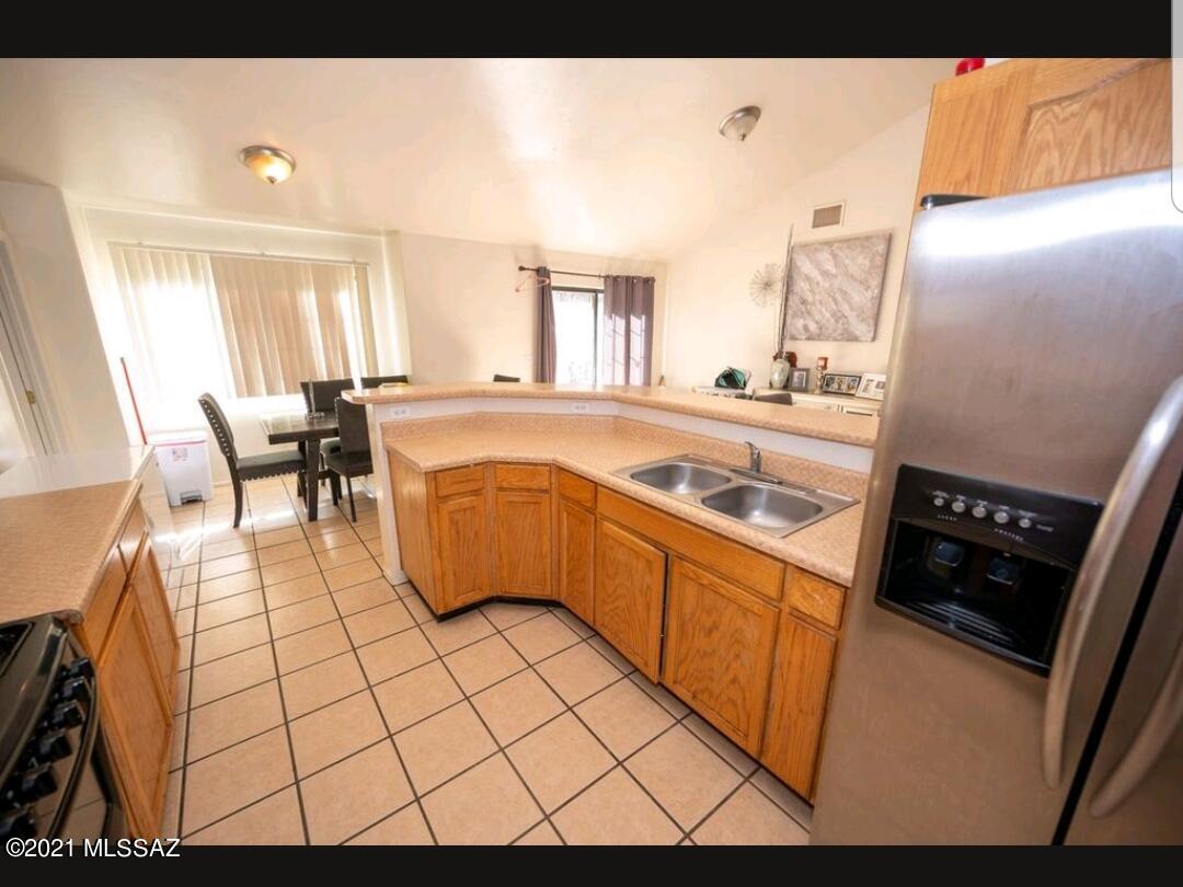 1375 Pendleton Drive Rio Rico, AZ 85648 - Photo 19 of 25 a kitchen with stainless steel appliances a stove a sink a counter top space and cabinets