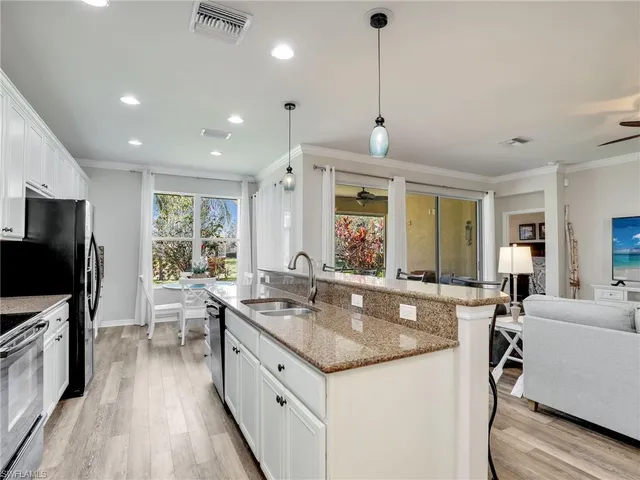 a kitchen with a table chairs and white cabinets