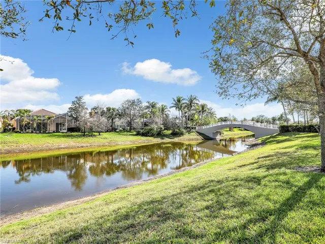 a view of a lake with houses in back