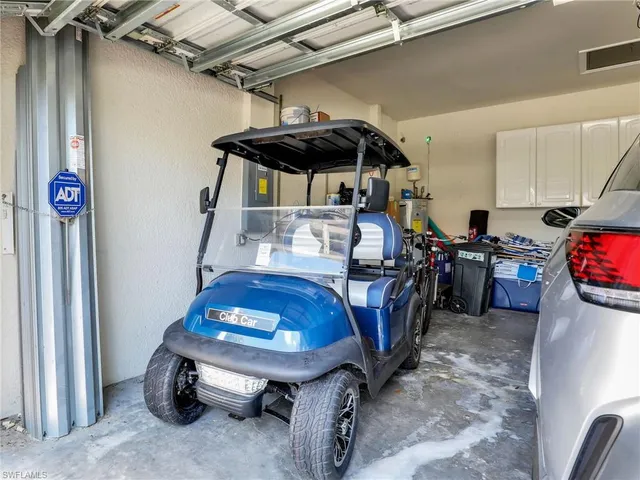 a view of a street with cars on both side of the road