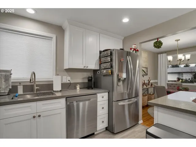 a kitchen with stainless steel appliances granite countertop a refrigerator and a sink
