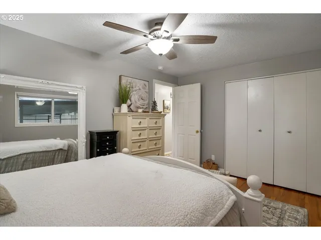 a balcony with table and chairs and potted plants