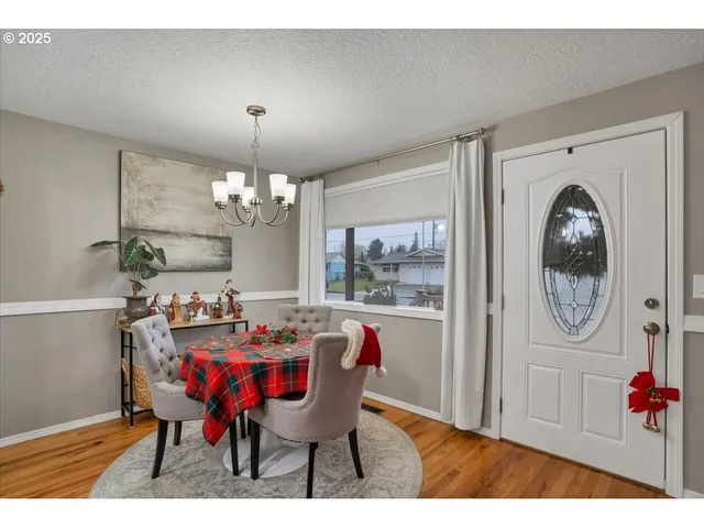 a view of a dining room with furniture and chandelier