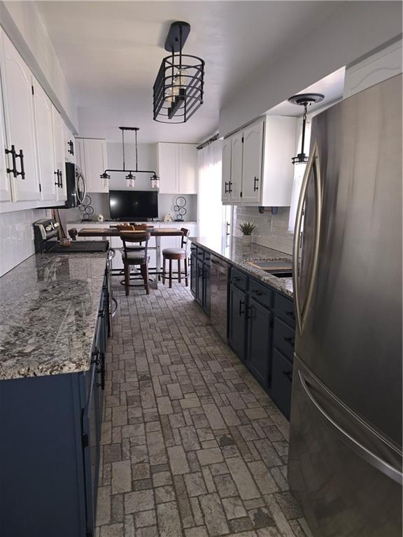 141 Hall Road Slippery Rock, PA 16057 - Photo 9 of 28 a kitchen with stainless steel appliances a sink stove and refrigerator