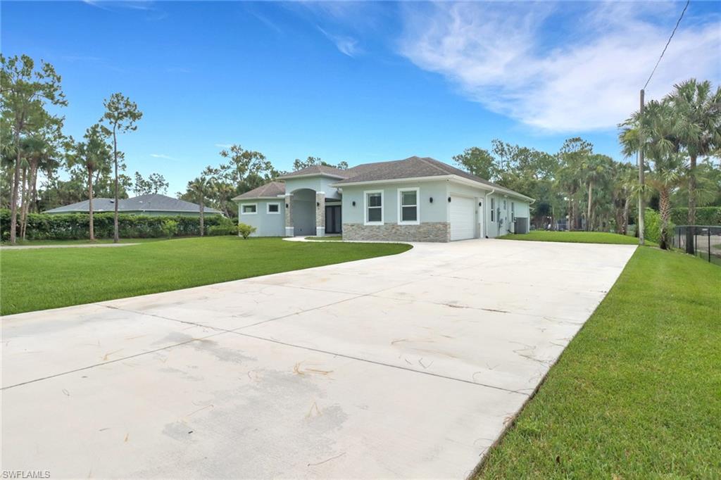 1086 21st Street Southwest Naples, FL 34117 - Photo 2 of 50 a view of house with yard and green space