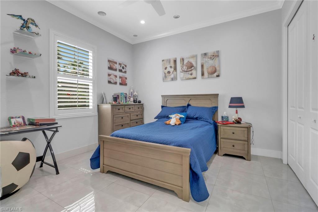 1086 21st Street Southwest Naples, FL 34117 - Photo 23 of 50 a bedroom with a bed and cabinets