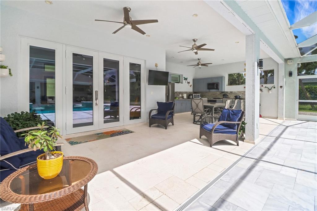 1086 21st Street Southwest Naples, FL 34117 - Photo 29 of 50 a living room with patio furniture and a potted plant